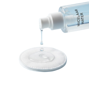 Using micellar water on a cotton pad for lightweight makeup removal