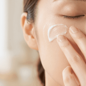 Woman-gently-applying-cream-remover-on-her-cheek-with-fingertips-avoiding-friction-on-sensitive-skin.